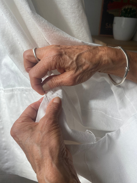 Woman's hands sewing curtains. Sewing by sewing. Woman sewing.